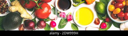 Olive oil, vinegar, vegetables and spices on white stone background. Making salad, cooking, clean eating, dieting concept. Flat lay Stock Photo