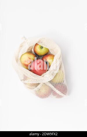 Red apples in reusable cotton bags. Zero waste, Recycling, Sustainable lifestyle concept Stock Photo