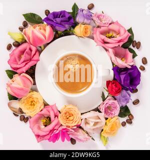 Morning coffee and a beautiful flowers on white background. Cozy breakfast. Flat lay composition for bloggers, magazines, web designers, social media Stock Photo