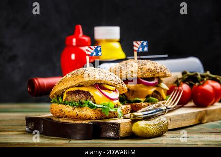 Homemade beef and ciabatta hamburgers on wooden background, space for text Stock Photo