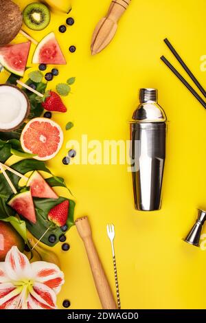 Fruits, berries, tropical plants and bar equipment on yellow background, flat lay Stock Photo