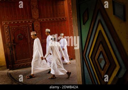 Tiwi, Oman. 30th May, 2014. A group of young Omani men seen wearing traditional clothes, Nizwa souk, Oman.Often overlooked as a potential travel destination and yet its rich history and centuries old culture that has so much to offer. Oman is an incredibly diverse landscape of tropical palm fringed wades, remote deserts and green terraced mountains, thriving Souks and one of the most welcoming people of the Arabian Gulf region and must deserve further attention. Credit: John Wreford/SOPA Images/ZUMA Wire/Alamy Live News Stock Photo