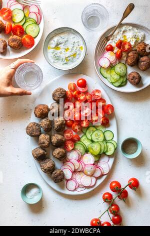 Vegetarian meatballs with tzatziki sauce and vegetables on the plate Stock Photo