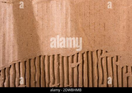 Top view of torn edges corrugated brown cardboard sheet of paper texture or background flat lay, Folded recycle carton paper box Stock Photo