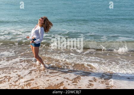 Woman on holiday enjoying the sea Stock Photo