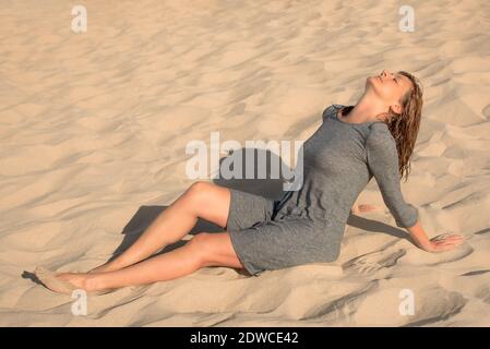 Woman sitting in the dunes Stock Photo