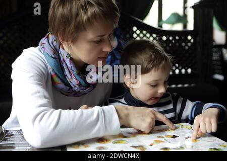 Mother and her son looking at menu in restaurant Stock Photo