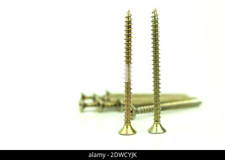 Construction metal screws on a white background. Self-tapping screws as background Stock Photo