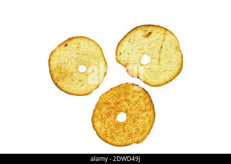 Round toasts of white bread on an isolated white background. Fresh and crispy white bread croutons with spices Stock Photo