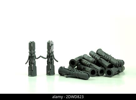 Old dowels on an isolated white background. The concept and idea of a dowel in the form of people and holding hands Stock Photo