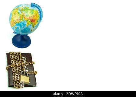 Globe and passport with lock on a white background. Globe, planet earth and passport wrapped in chain and closed padlock Stock Photo