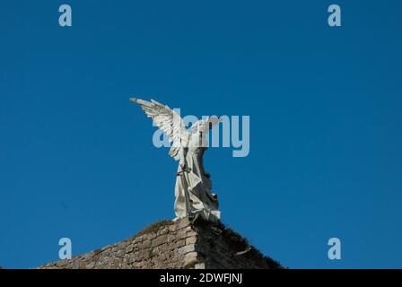 White exterminating angel on a cemetery wall in Comillas in the north of Spain Stock Photo
