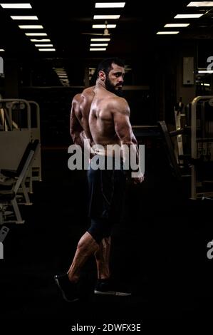 Premium Photo | Muscular men is hitting rear double bicep pose