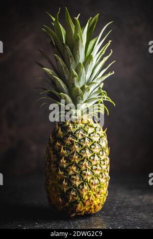 Ripe pineapple. Pineapple on a black table. Stock Photo