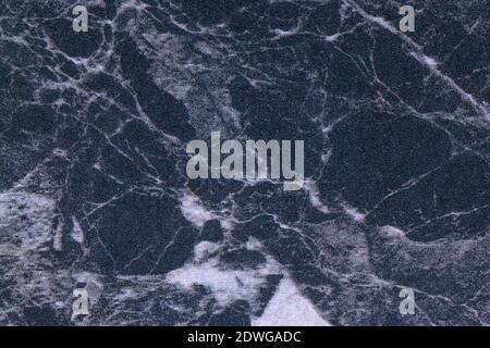 Texture of dark blue and gray marble for tabletop with light lines of pattern, macro background. Artificial black stone countertop from mineral tile f Stock Photo