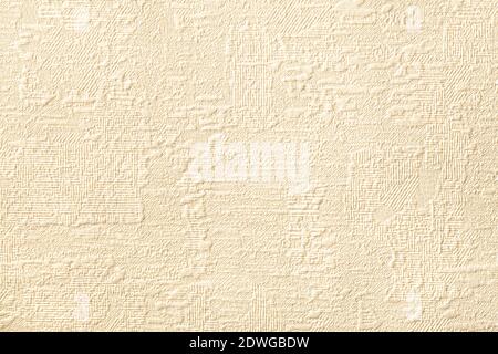 Texture of light beige wallpaper with relief and corrugated pattern. Paper cream background with modern design. Surface closeup. Stock Photo