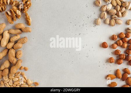 Mix of nuts. Frame made of almonds, hazelnuts, pistachios, peanuts, walnuts. Healthy snacks, vegetarianism. Copy space. Stock Photo