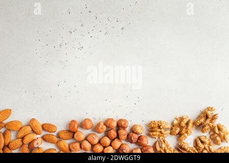 Mix of nuts. Frame made of almonds, hazelnuts and walnuts. Healthy snacks, vegetarianism. Copy space. Stock Photo