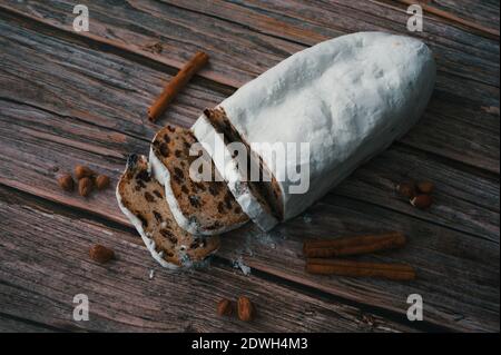 High angle view of Christmas cake with cinnamon and nuts on wooden background Stock Photo