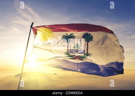 Puerto Plata province of Dominican Republic flag waving sunrise mist fog Stock Photo