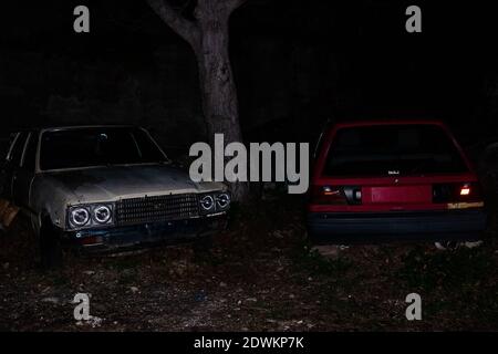 Pilion, Greece - December 30, 2017: A red and a white car under the tree Stock Photo