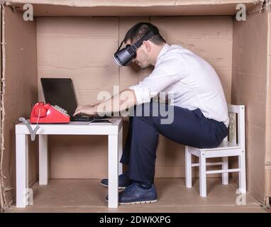 businessman in virtual reality glasses working persistently on the laptop Stock Photo