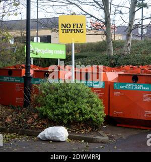 Rubbish bag dumped beneath No Fly Tipping sign, Sainsbury's recycling centre, Calne, England Stock Photo