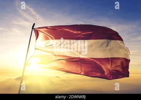 Leuven of Flemish Brabant of Belgium flag waving on the top sunrise mist fog Stock Photo