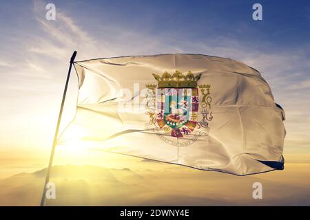 Governor of Puerto Rico flag waving on the top sunrise mist fog Stock Photo