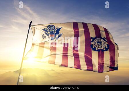 United States Marine Corps flag waving on the top sunrise mist fog Stock Photo