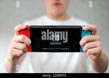 A teenager playing on a Nintendo Switch computer game console Stock Photo