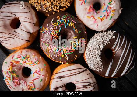 Colorful donuts on stone table. Top view with copy space Stock Photo