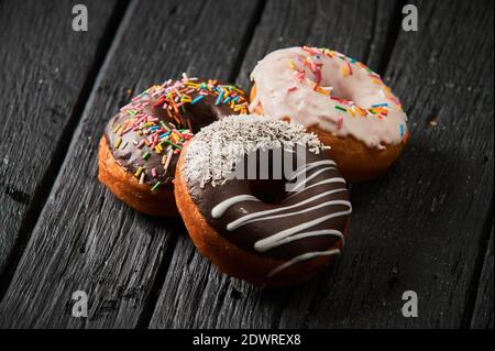 Colorful donuts on stone table. Top view with copy space Stock Photo