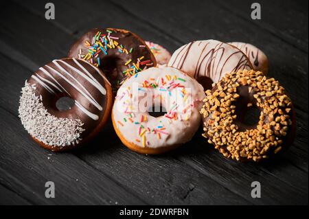 Colorful donuts on stone table. Top view with copy space Stock Photo