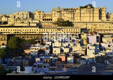 Panoramic view from a roof top to the Udaipur City Palace and old city in the morning. Beautiful historic architecture of Mughal Empire. Rajasthan Stock Photo