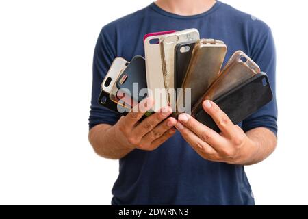 Man holding a choice of multicolored plastic back covers for mobile phone. Smart phone protector accessories. Isolated on white background. Stock Photo