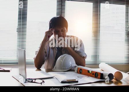 architect or engineer thinking and planning seriously and looking on blueprint Stock Photo