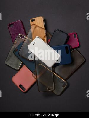 Pile of multicolored plastic back covers for mobile phones on black background Stock Photo