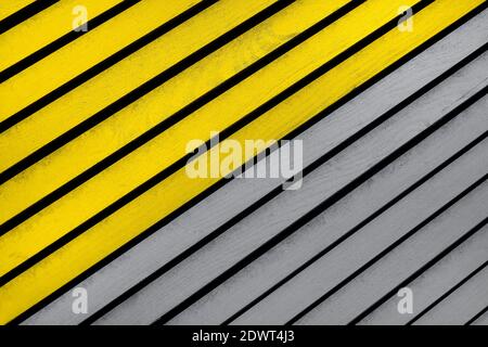 Wooden textured background with diagonal planks. Vintage gradient yellow and gray wood background texture with knots. Demonstrating trendy colors 2021 Stock Photo