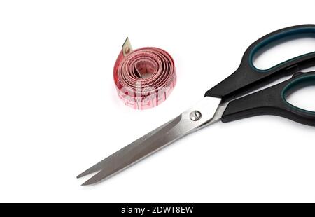 Scissors and pink tape measure on a white background