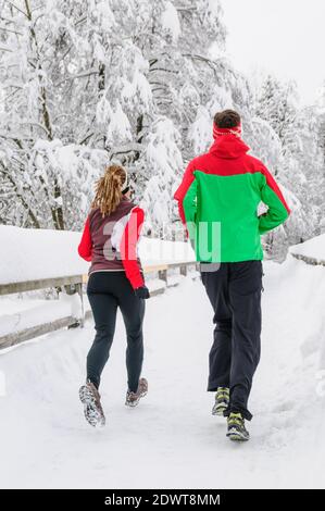 Two joggers during running workout in wintry nature Stock Photo