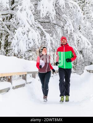 Two joggers during running workout in wintry nature Stock Photo