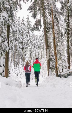 Two joggers during running workout in wintry nature Stock Photo