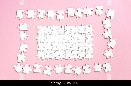 White jigsaw puzzle with unconnected pieces Stock Photo