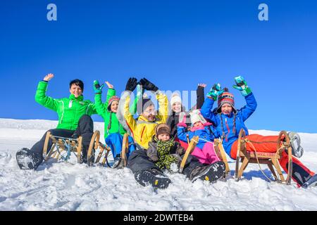 Funny afternoon in wintertime on sleigh with family Stock Photo