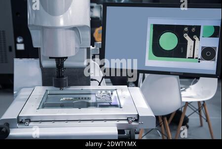 CNC vision inspecting machine measuring electronics circuit board. Industrial manufacturing Stock Photo