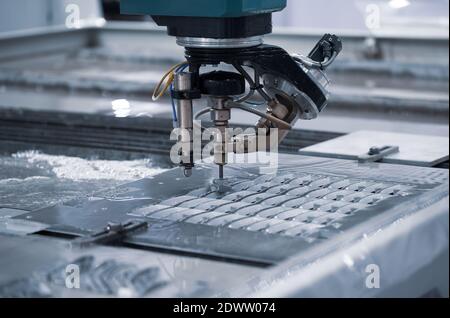 Modern CNC Abrasive water jet cutting machine using high pressure water jet to cut metal. Industrial metalworking machinery Stock Photo