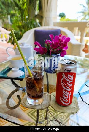 Can of Coca Cola light or diet Coke, glass with environmentally friendly straw made from stalk of a plant, La Veranda Resort, Phu Quoc, Vietnam, Asia Stock Photo