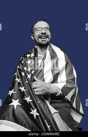 Laughing man isolated over dark blue background. Black and white portrait. Stock Photo