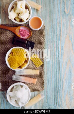 Ingredients for homemade lip balm: shea butter, essential oil, mineral color powder, beeswax, coconut oil. Homemade lip balm lipstick mixture. Stock Photo